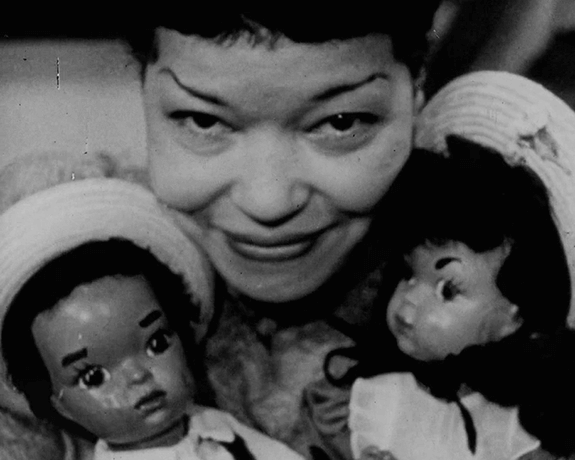 Jackie Ormes with Patty-Jo dolls, film still, One Tenth of a Nation, 1953, Library of Congress